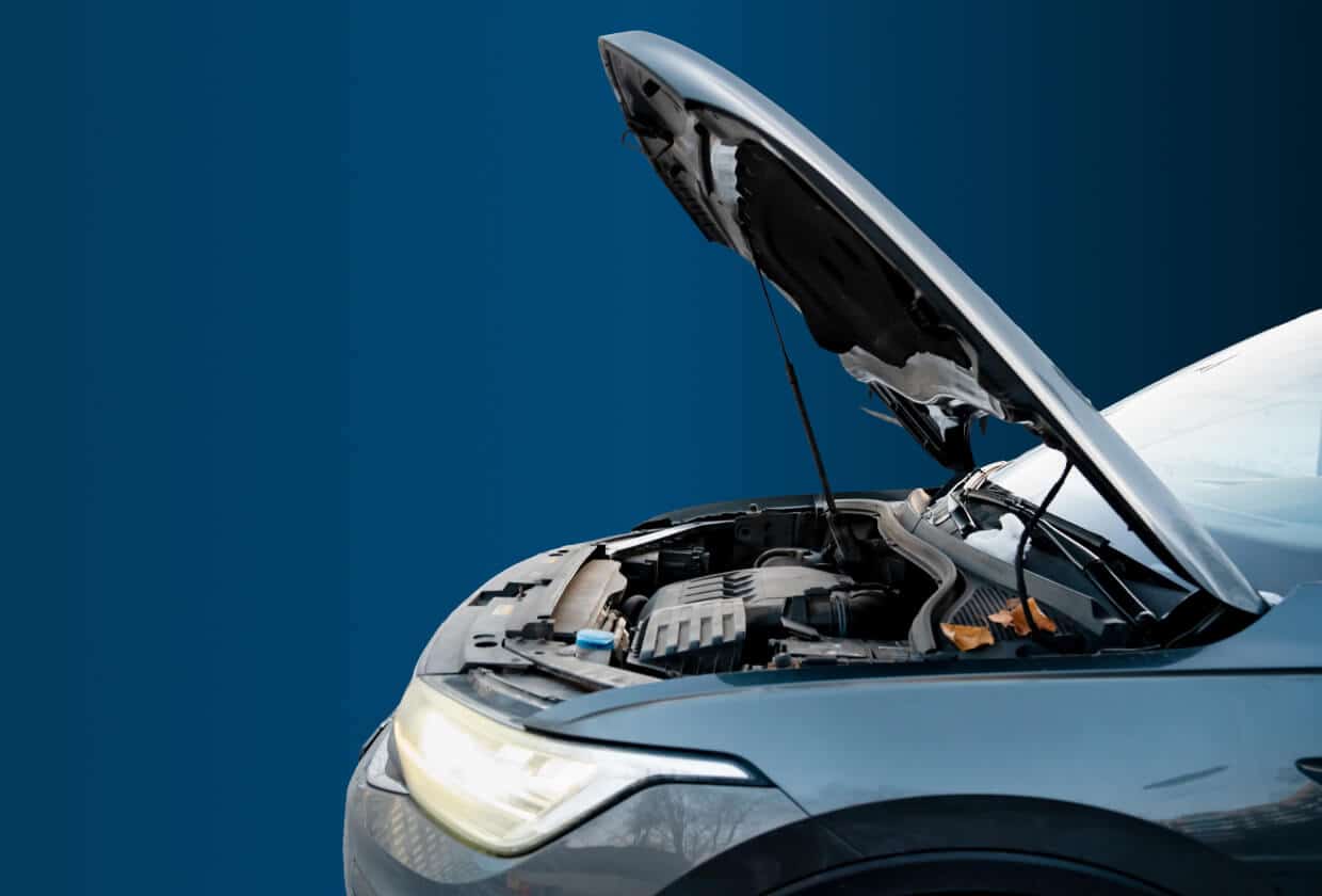 Vehicle inspections in Madison, WI at Torque Automotive. A close-up of a car with its hood open, revealing the engine bay, set against a blue gradient background.